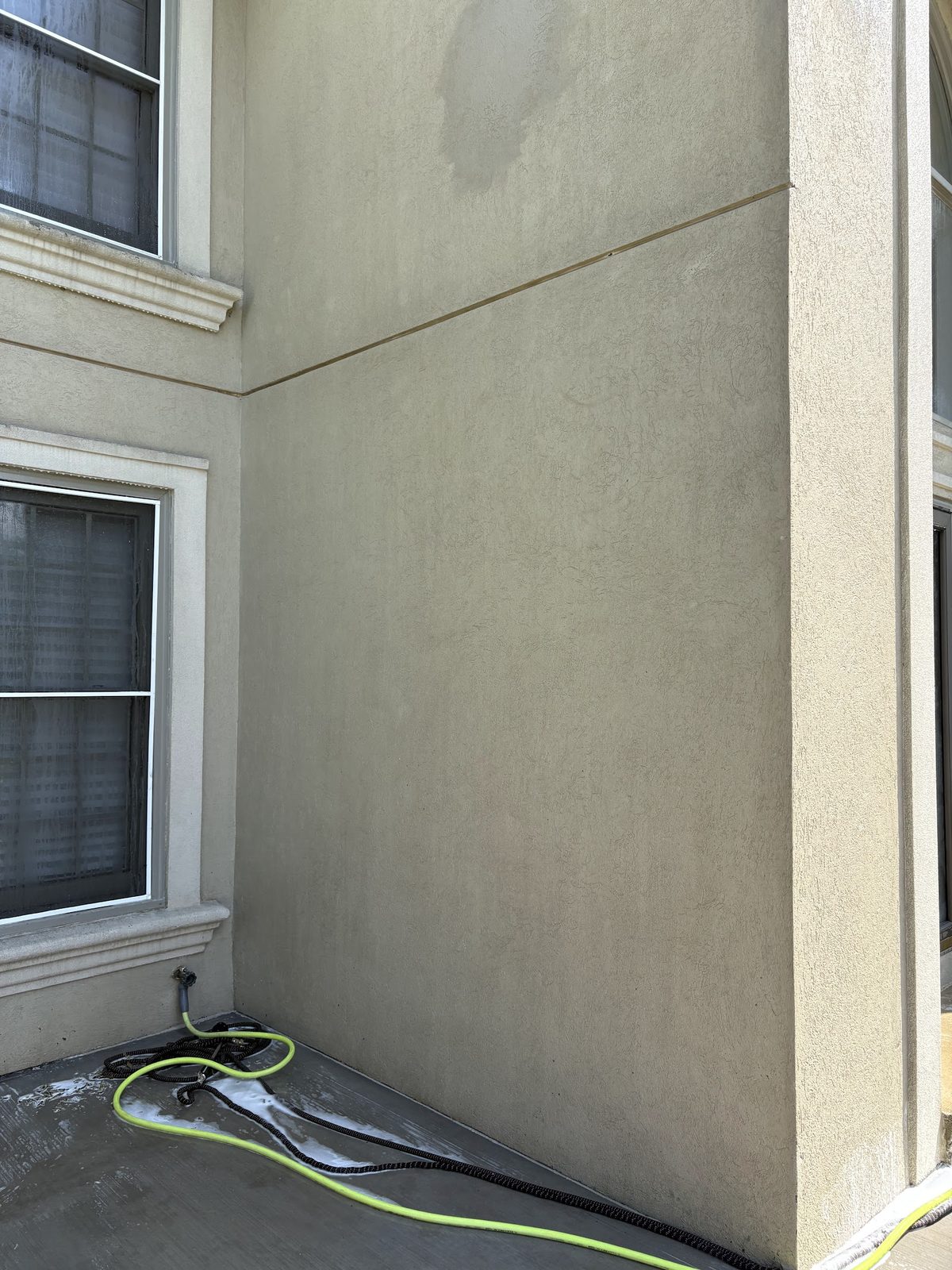 Stucco wall cleaned to original color after soft washing